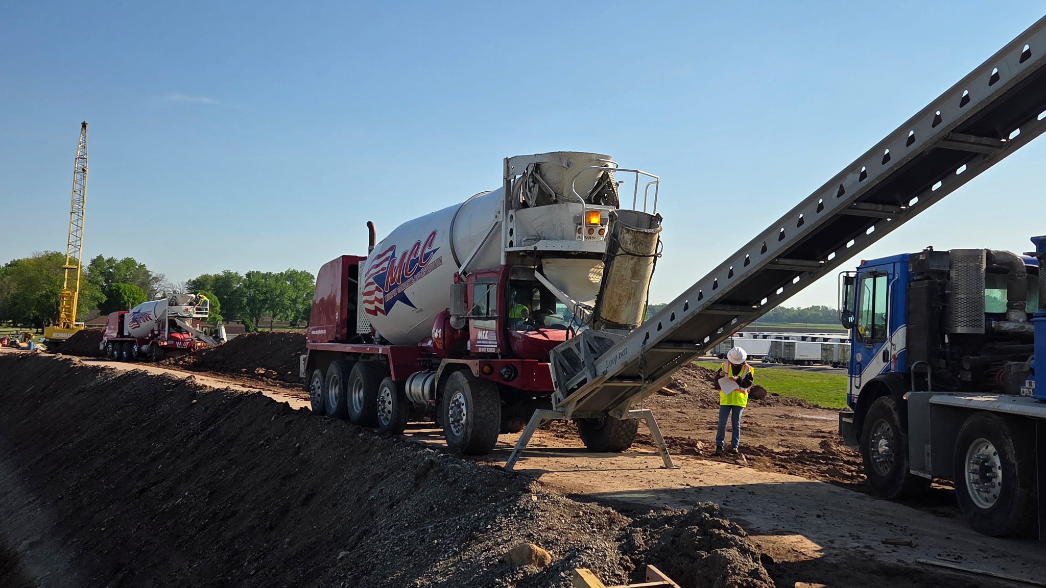 An MCC, Inc. ready mixed concrete truck discharging onto a conveyor on the I-41 corridor